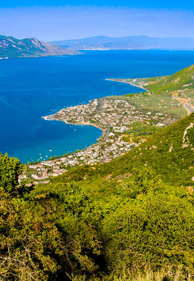 Aerial view of Kamena Vourla coastline with blue sea and lush green mountains