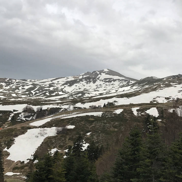 Early spring view of Mount Parnassos with melting snow and evergreen trees