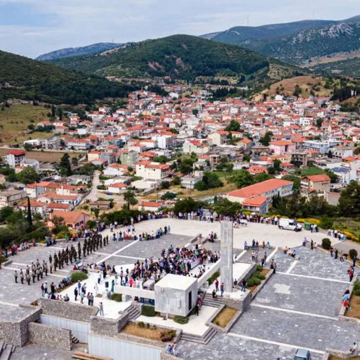Aerial view of Distomo village with people in the town square