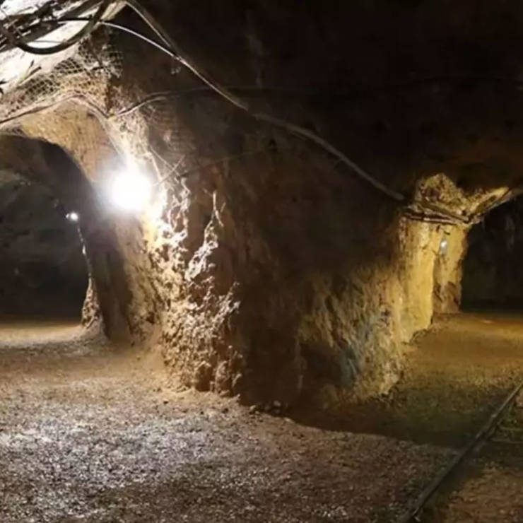 Interior of Bagonetto mining tunnel at the Mining Park of Fokida, showing tracks of the miner's old train and rock walls