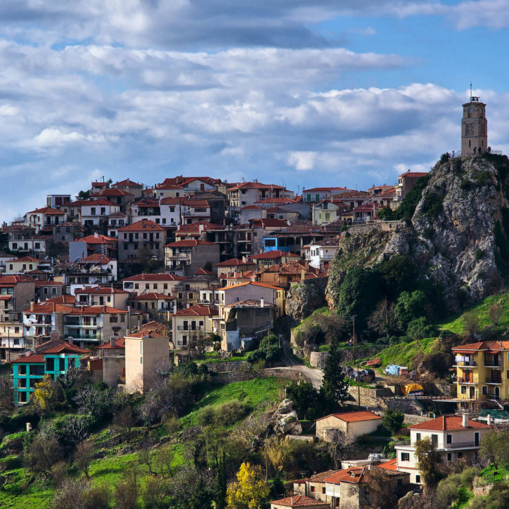 Picturesque Arachova village with red-roofed houses and the iconic stone clock tower