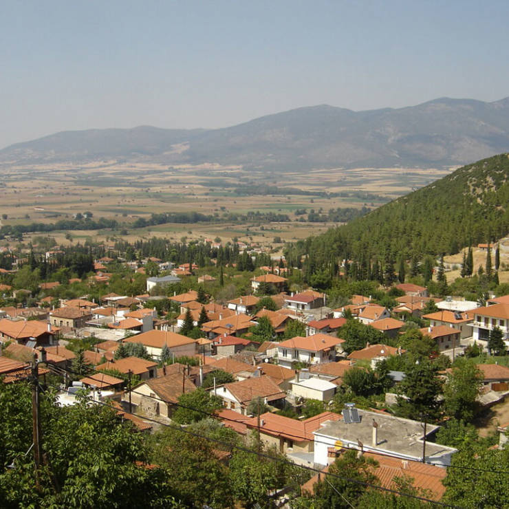 Panoramic view of Polydorsos Souvala nestled on the green slopes of Mount Parnassos