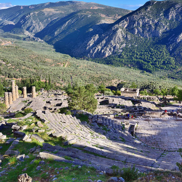 Ancient theater of Delphi surrounded by green mountains and scenic valley views