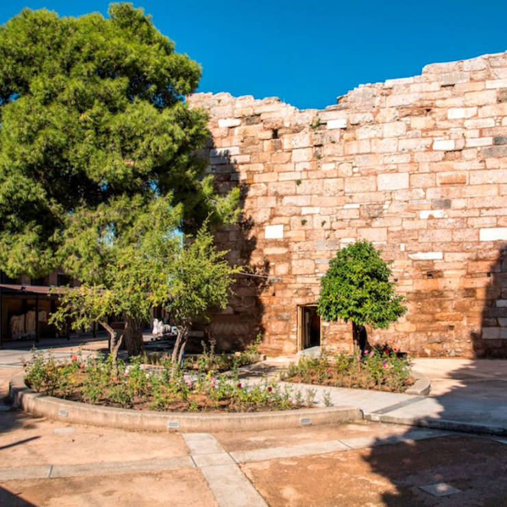 Stone church inside the town of Thebes with traditional masonry and adjacent houses